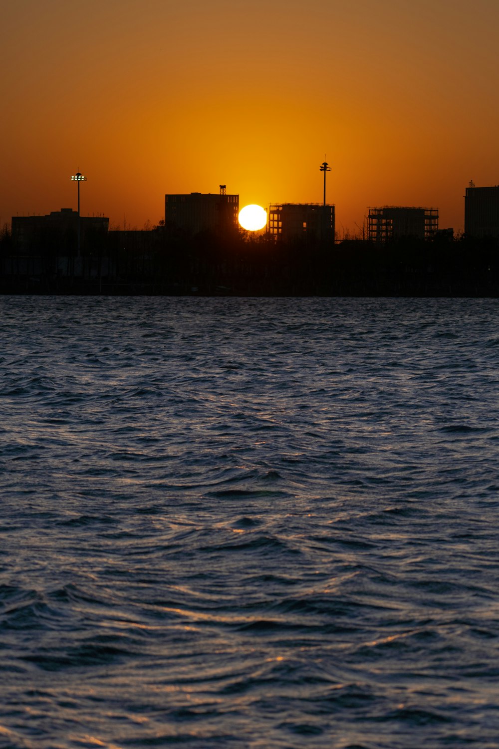 the sun is setting over a body of water