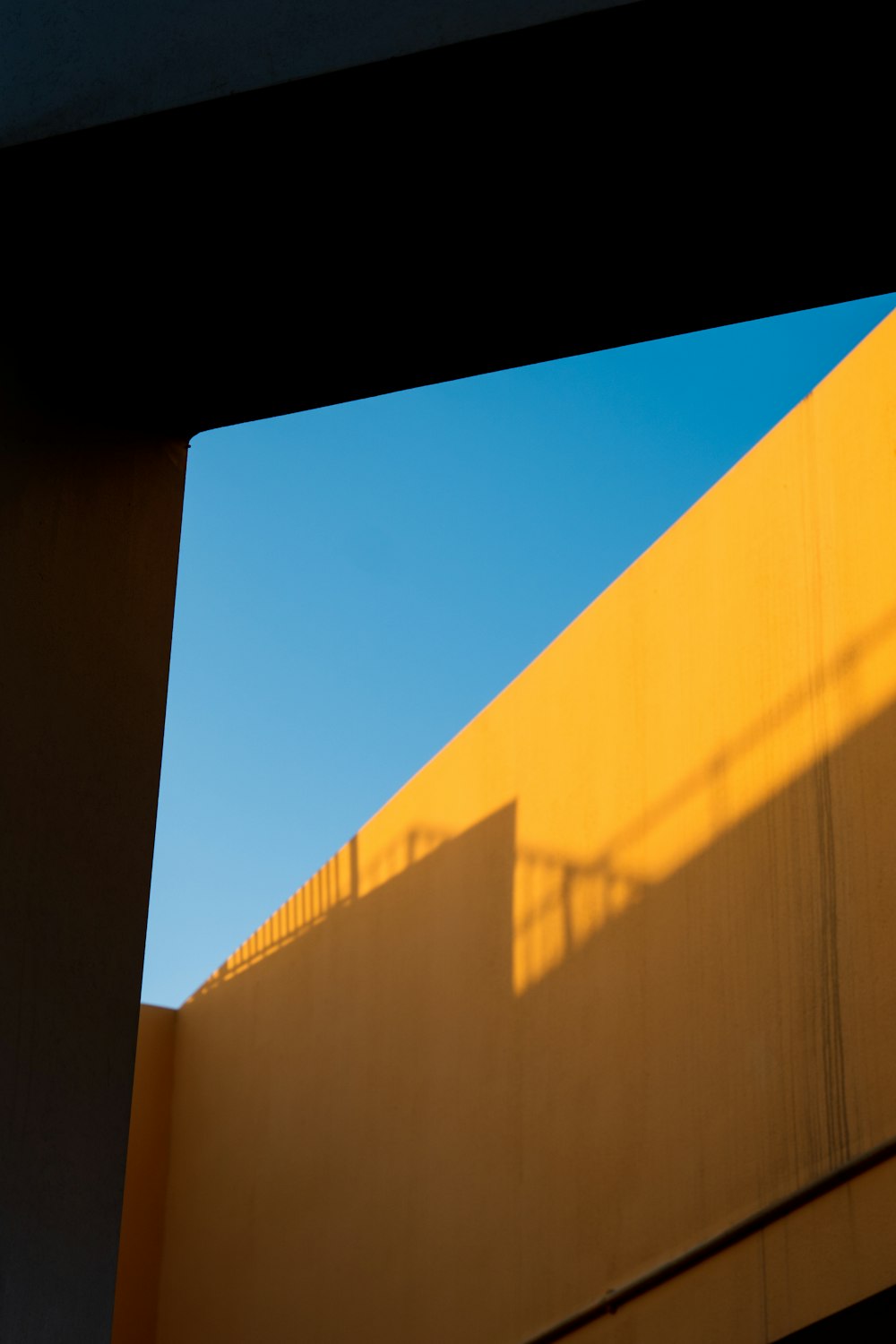 the shadow of a building on a wall