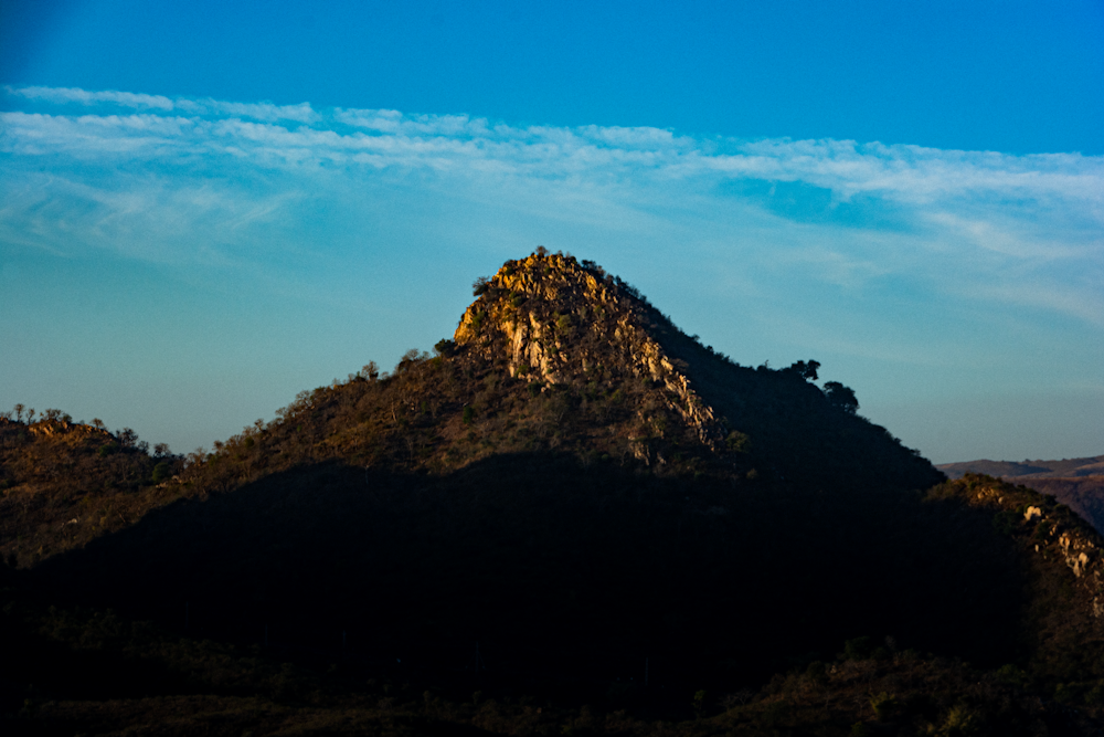 a very tall mountain with a sky in the background