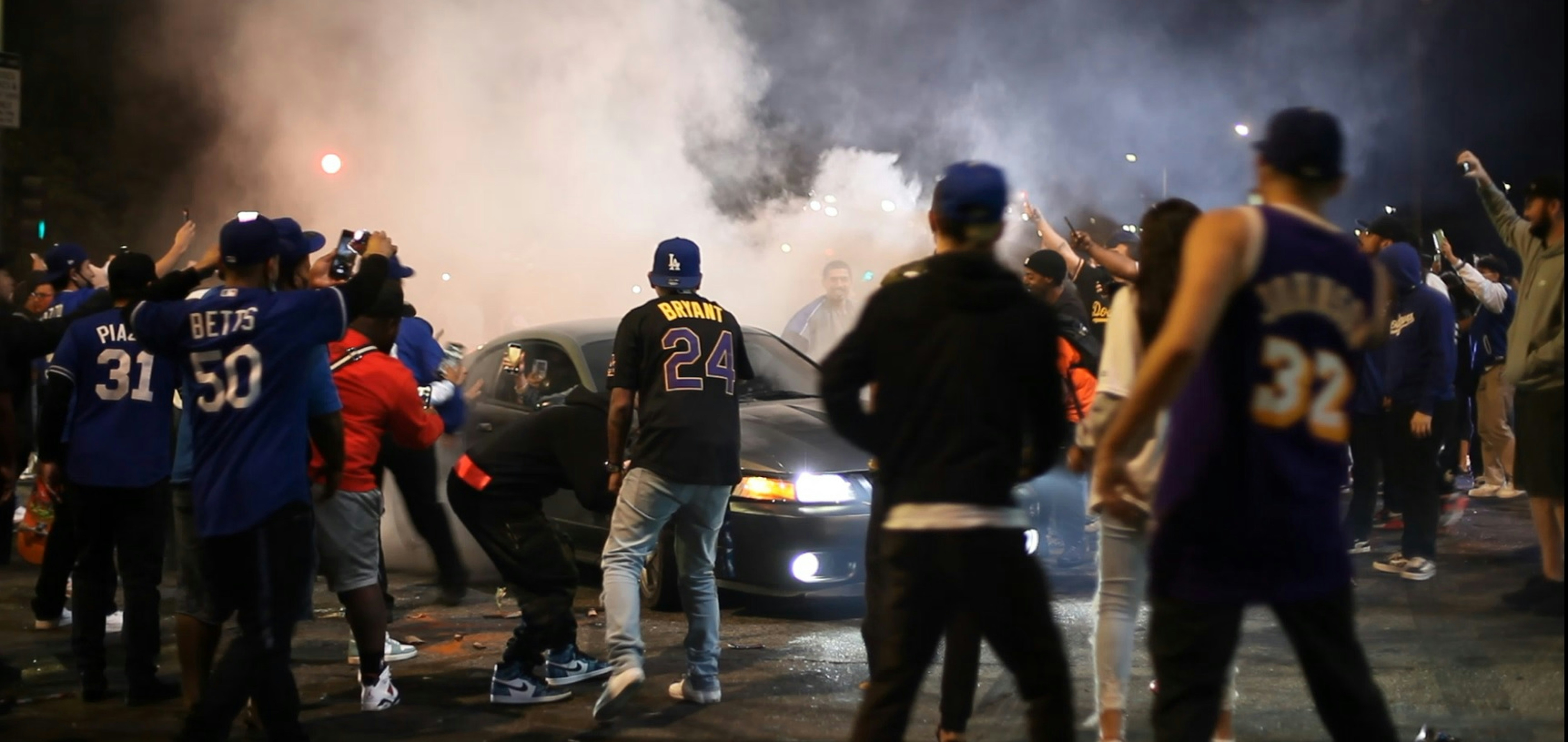 a group of people standing around a car