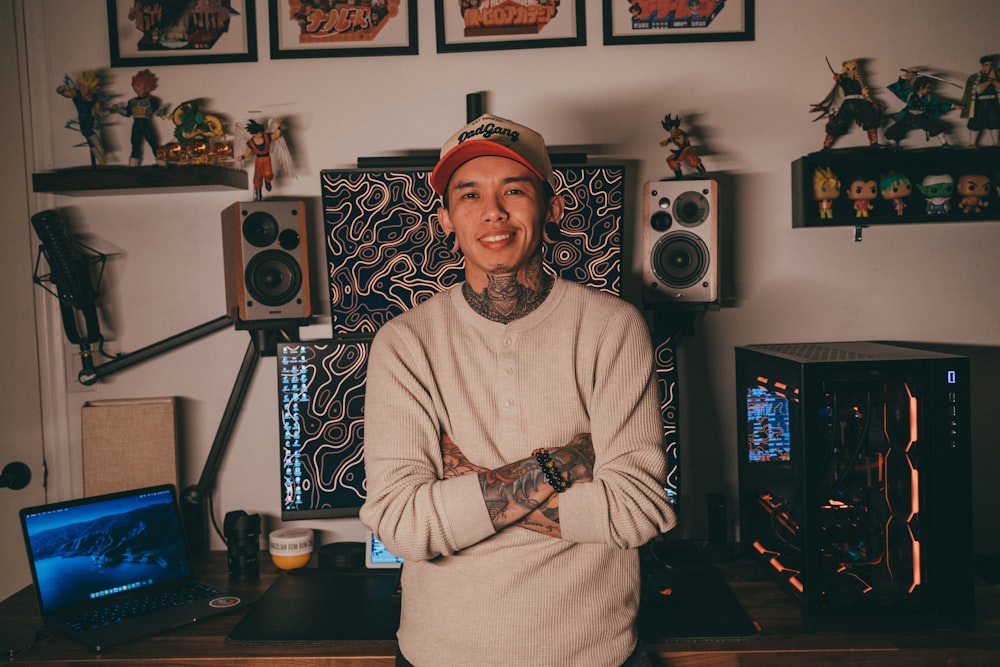 a man with tattoos standing in front of a desk