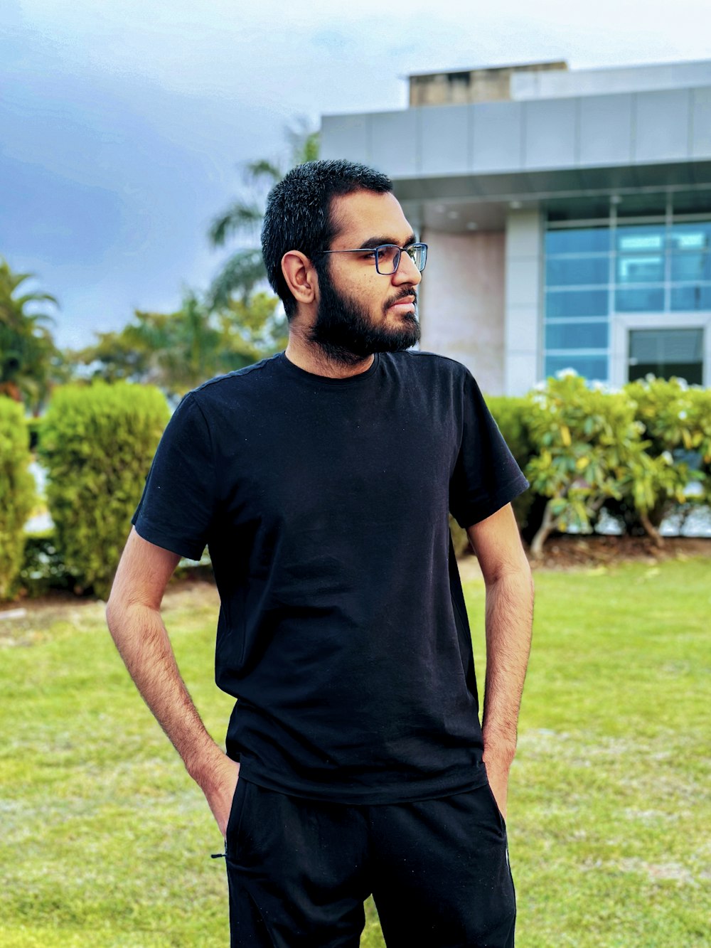 a man standing in front of a building with his hands on his hips