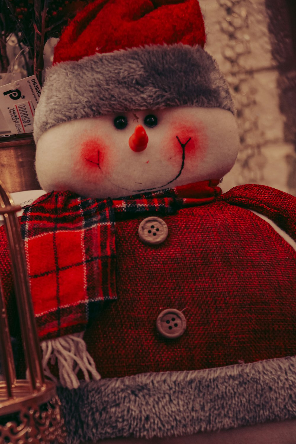 a stuffed snowman wearing a santa hat and scarf