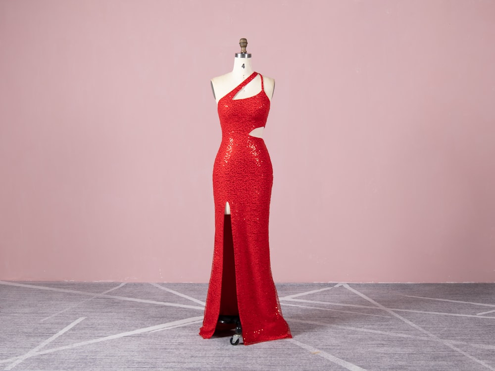 a red dress on a mannequin in a room