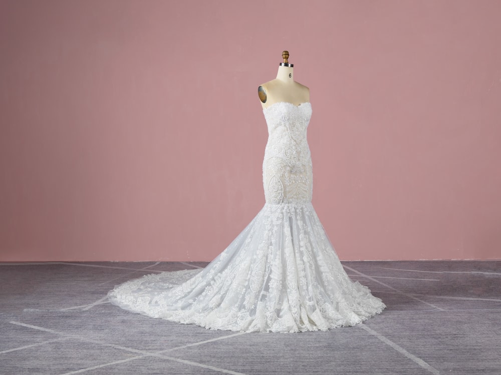 a white wedding dress on a mannequin