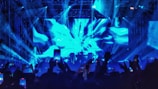 Dynamic live performance shot of ezwolff with glowing blue and red stage lights.