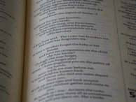 A child happily coloring a page filled with uplifting Bible verses and playful designs.