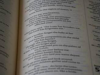 A child happily coloring a page filled with uplifting Bible verses and playful designs.