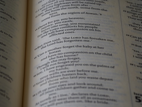 The page in the image contains text from a Bible open to a section with numbered verses. The text is printed in black ink on cream-colored paper, with varying font sizes for headings and verses.
