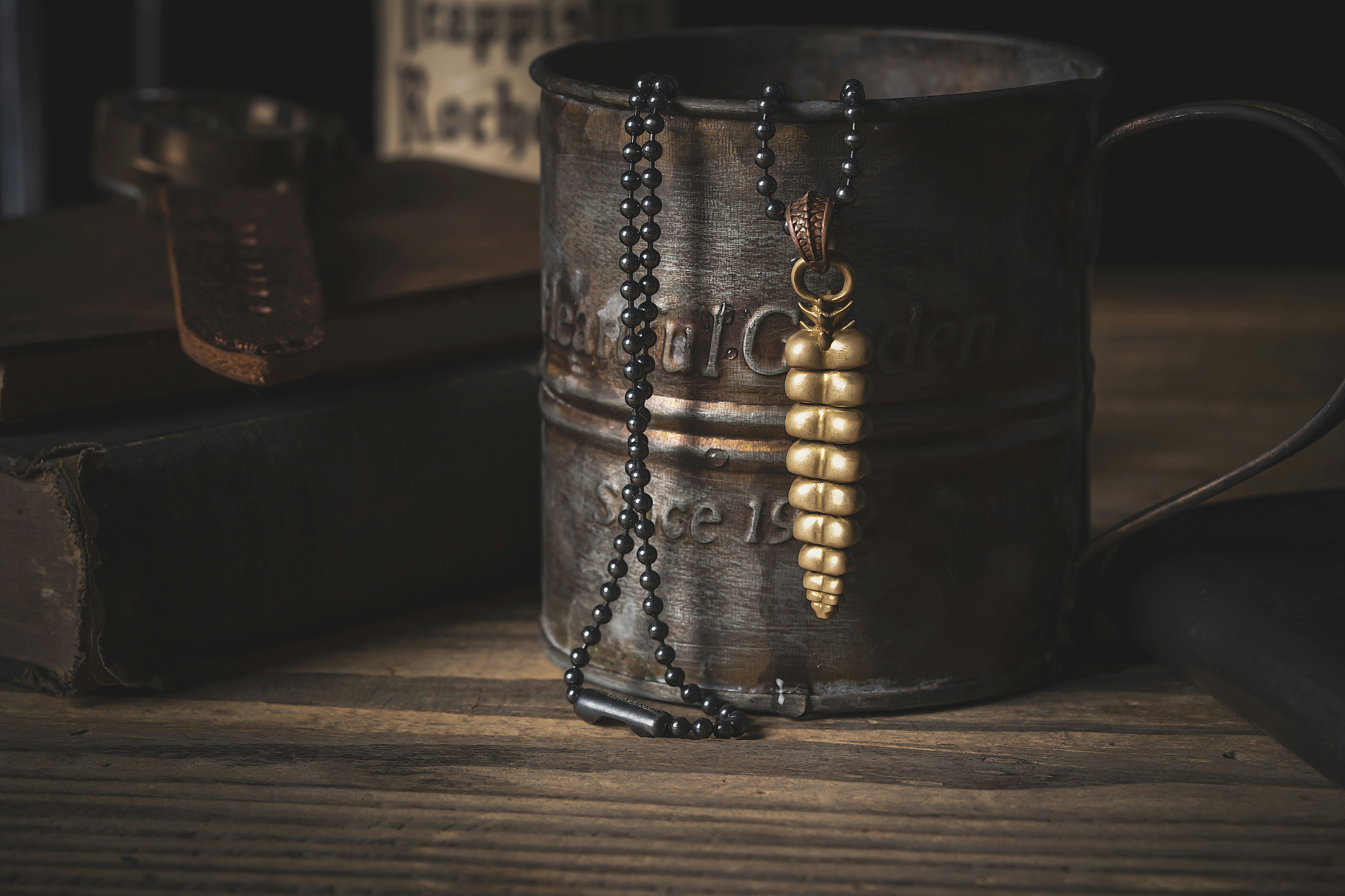 a coffee mug with a chain hanging from it