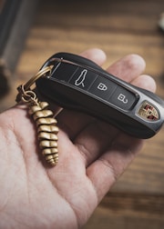 a person holding a car key in their hand