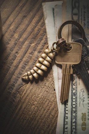 A close-up photo of legal documents and keys on a wooden table, symbolizing real estate contracts.
