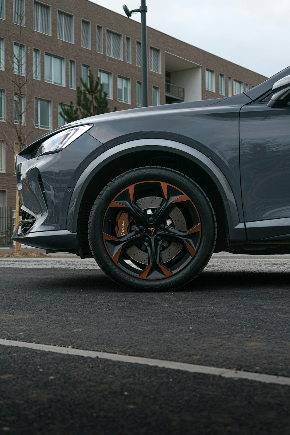 a car parked in a parking lot next to a building