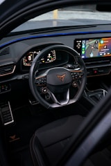 the interior of a car with a steering wheel and dashboard