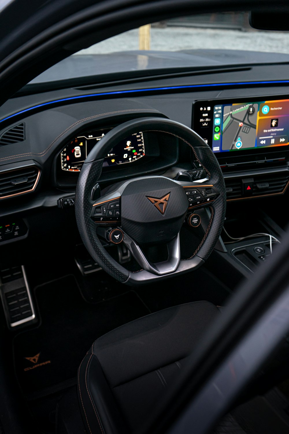 the interior of a car with a steering wheel and dashboard