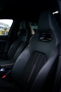 Interior view of a clean, freshly detailed car cabin with spotless seats and dashboard.