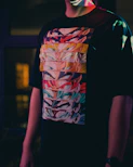 a man wearing a t - shirt with a colorful design on it