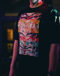 a man wearing a t - shirt with a colorful design on it
