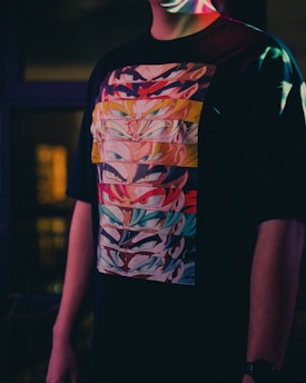 a man wearing a t - shirt with a colorful design on it