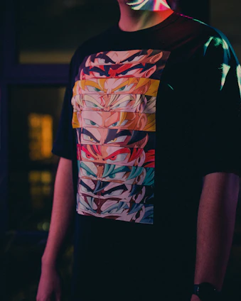a man wearing a t - shirt with a colorful design on it
