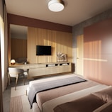 A beautifully designed modern bedroom with neutral tones and elegant furnishings.