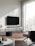 A modern living room featuring a wall-mounted TV with a sleek sound system underneath.