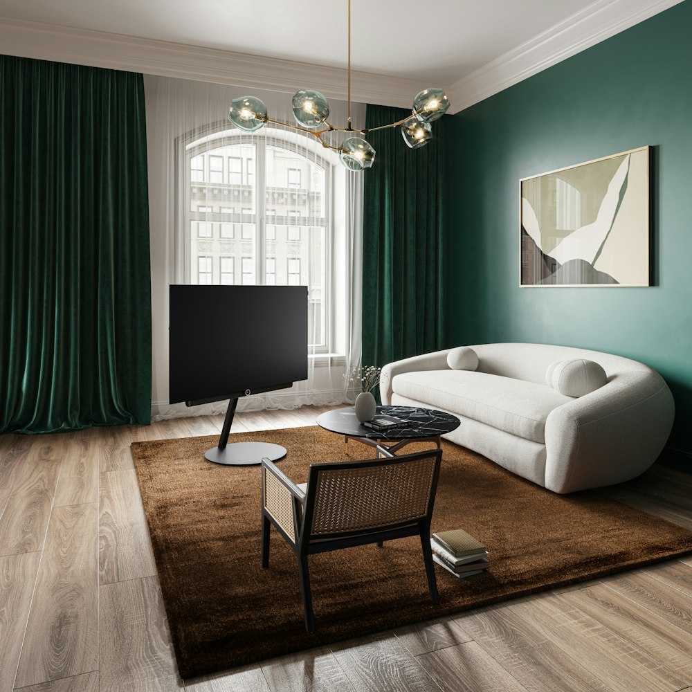 a living room with green walls and a white couch