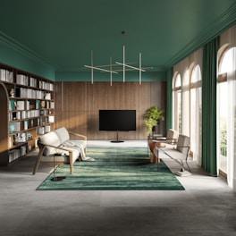a living room with a large book shelf and a television