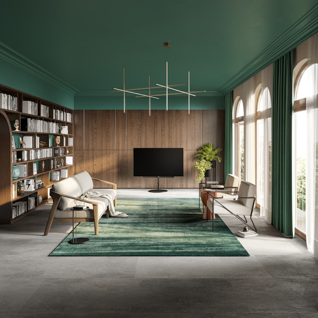 A sunlit modern living room with green accents and sleek furniture.