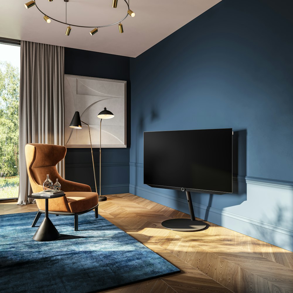 a living room with blue walls and a large flat screen tv