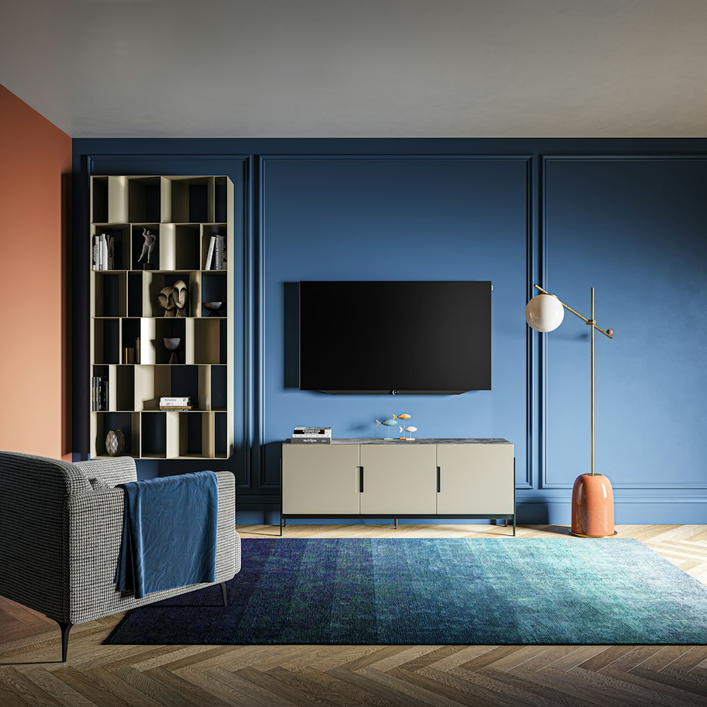 a living room with blue walls and a television
