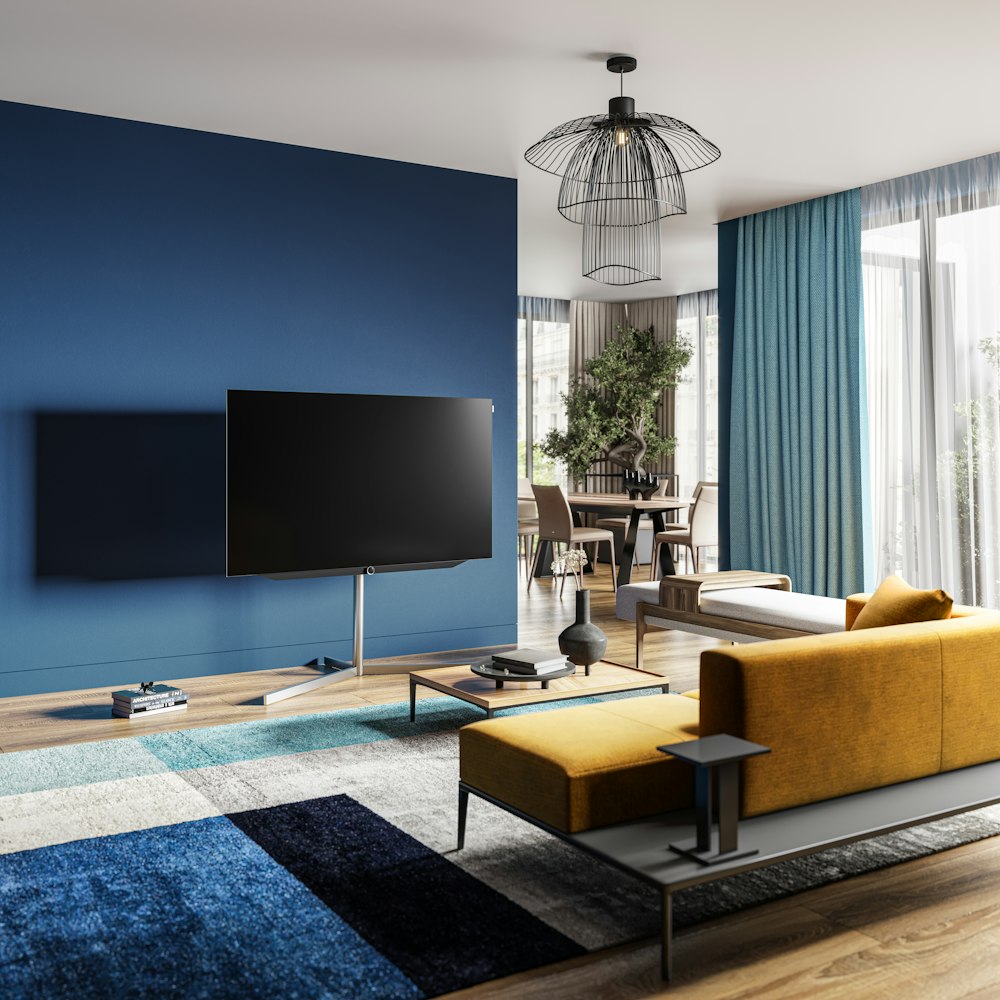 a living room with blue walls and a yellow couch