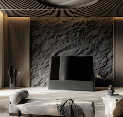 A sleek floating TV unit mounted on a warm-toned wall, surrounded by geometric cushions and an iron wall sculpture.