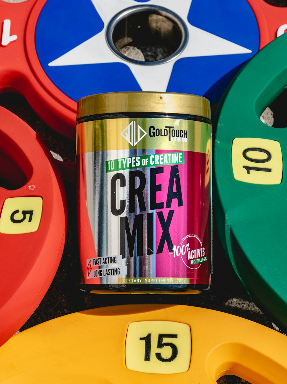 a can of crea mix next to a stack of colorful discs