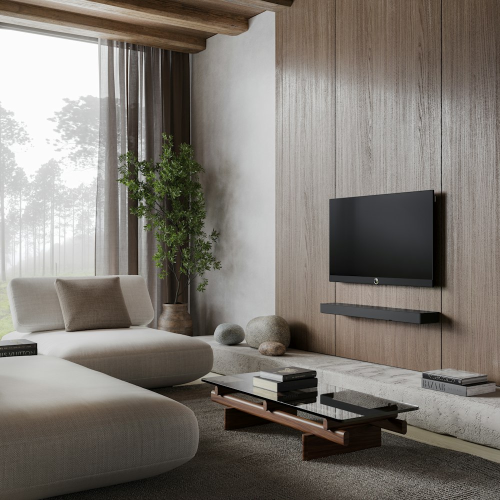 a living room with a couch, coffee table and television