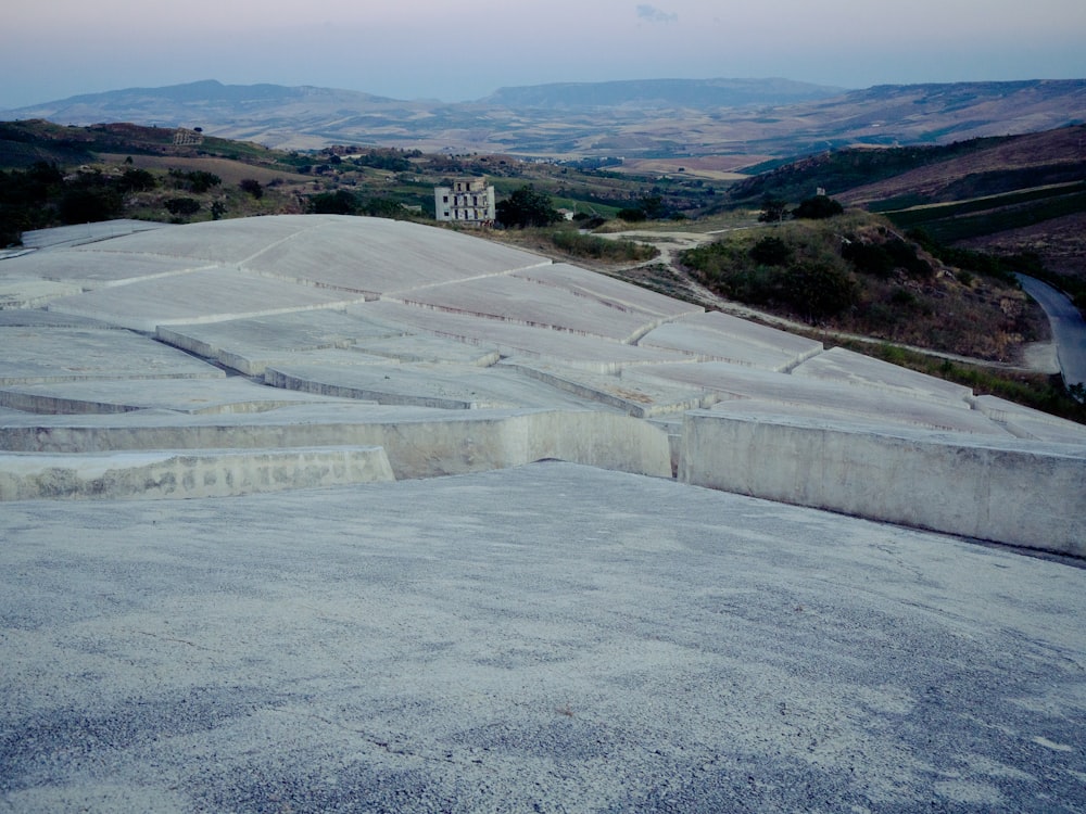 a concrete structure with steps and a building in the background