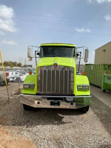 A modern truck with the grünklar logo parked outside a residential building during a cleanup.
