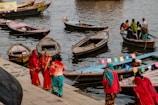 a group of people standing on a dock next to boats