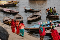 a group of people standing on a dock next to boats