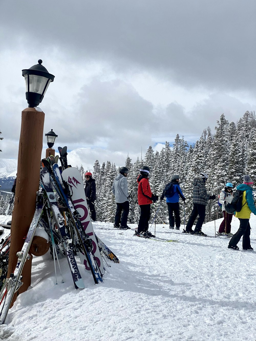 a group of people standing on top of a snow covered slope