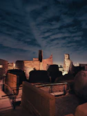 Ancient archaeological ruins bathed in deep purple twilight.