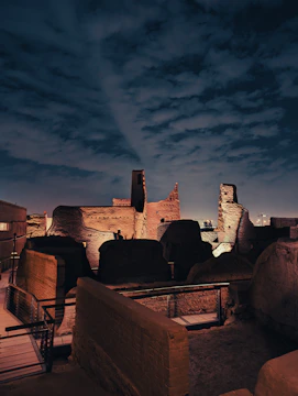 Ancient ruins under a moonlit sky with mysterious glowing runes