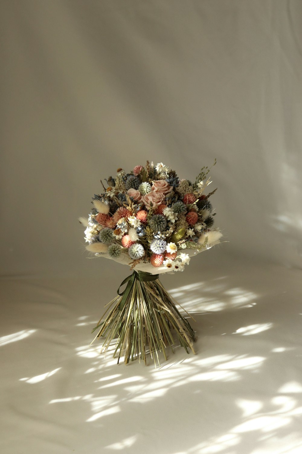 a bouquet of flowers sitting on top of a white table