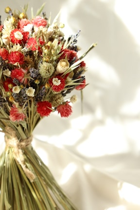 Elegant dried flowers tied with natural twine against a neutral backdrop.
