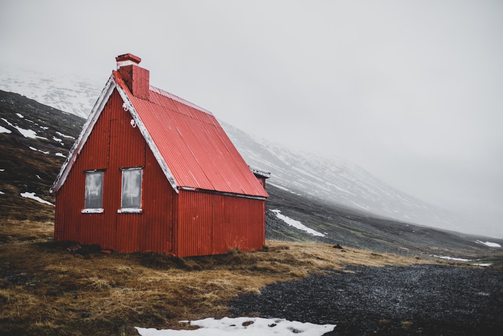 a small red building with a red roof