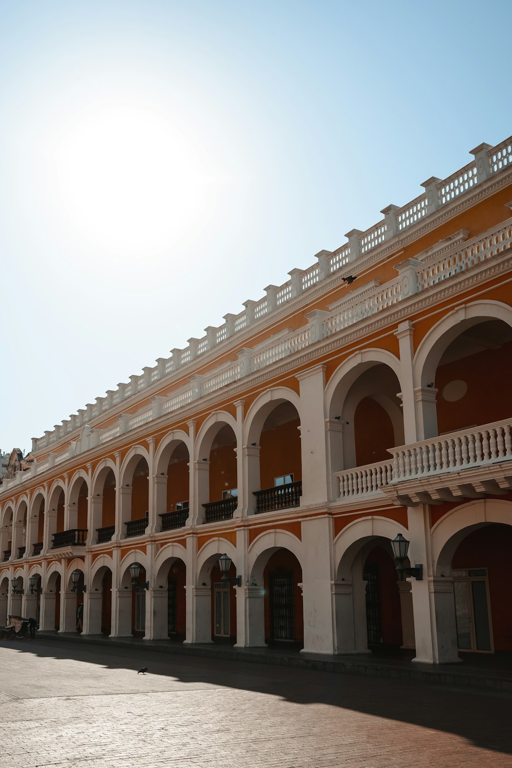 a building with arches and balconies on a sunny day