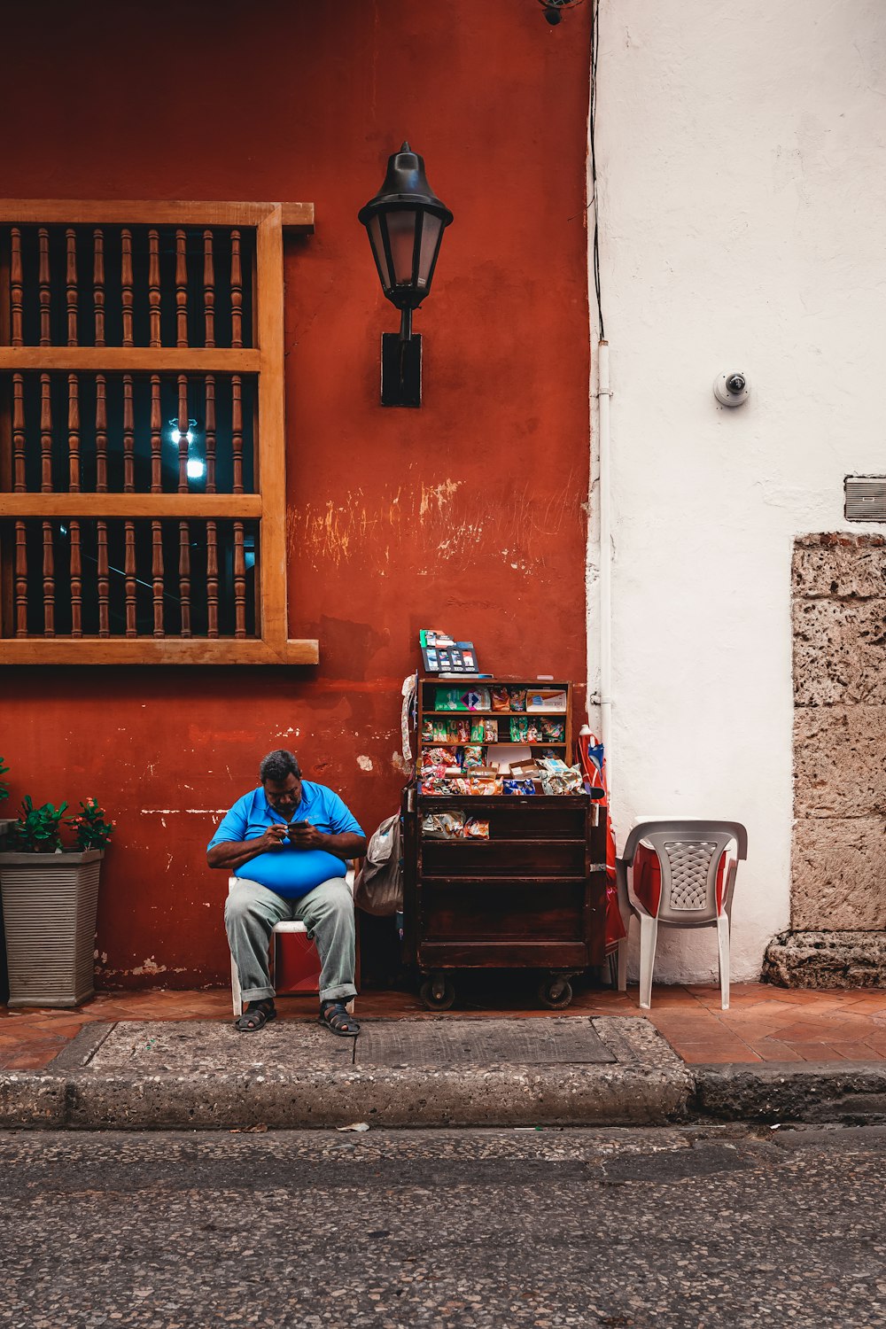 a man sitting on a chair in front of a store