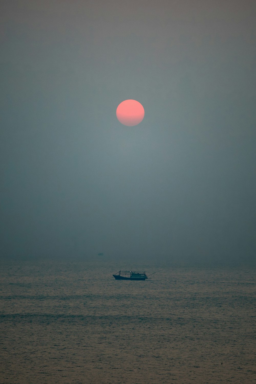 a small boat in the middle of a large body of water