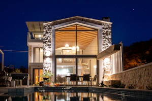 a house with a swimming pool at night