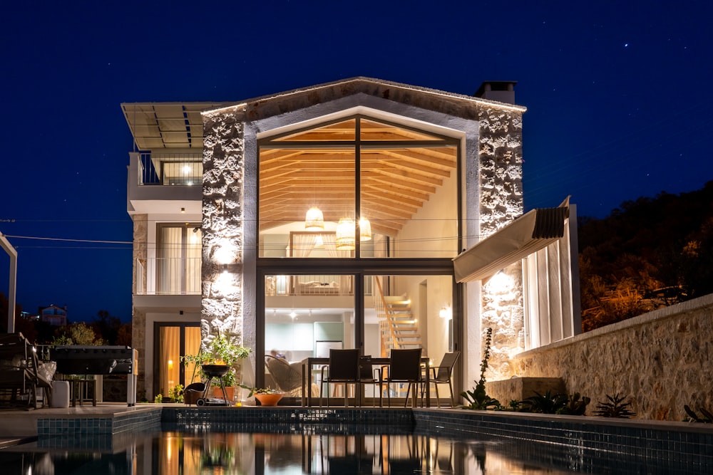 a house with a swimming pool at night